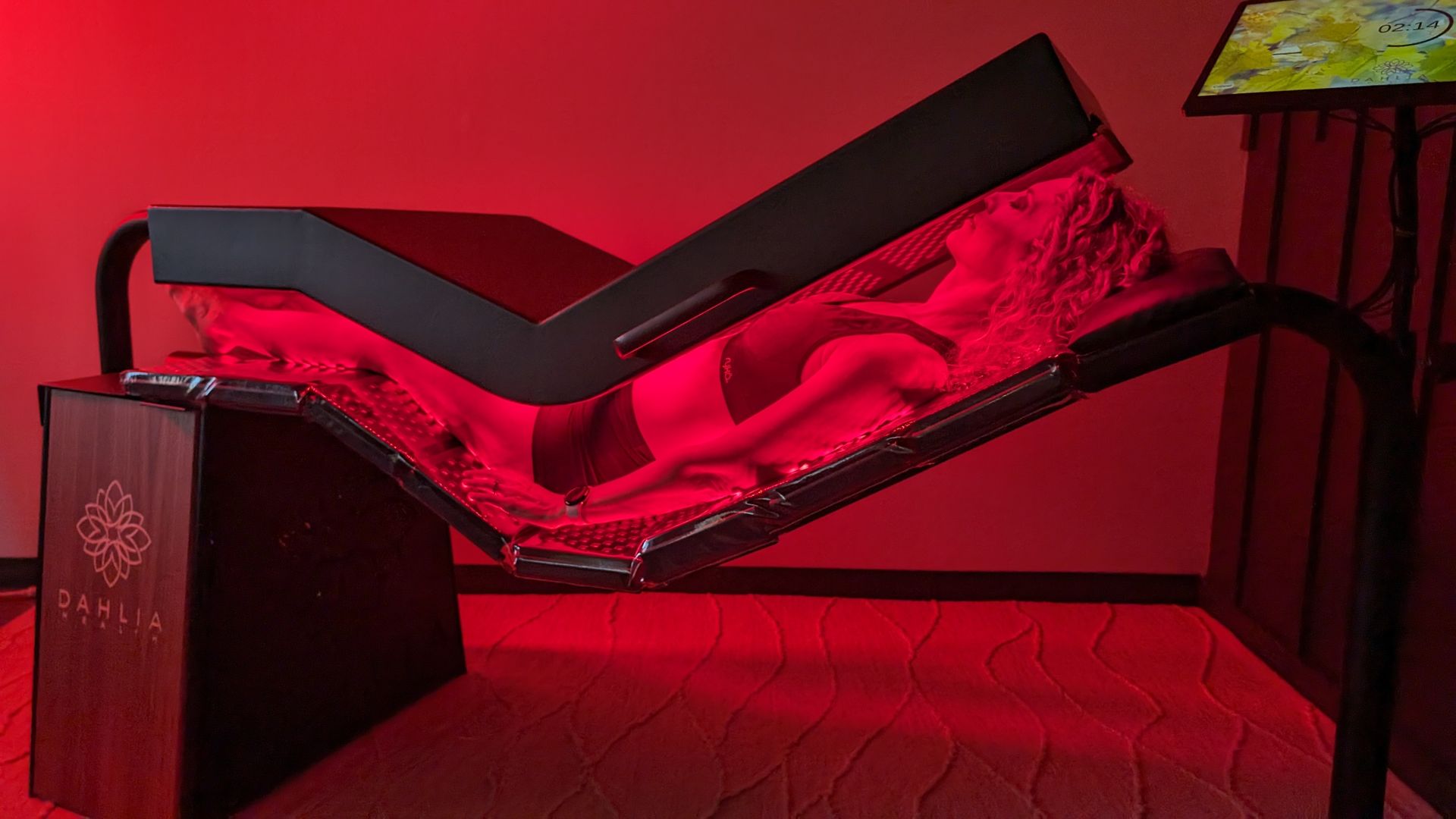 A patient lying in the Pinnacle full-body red light bed