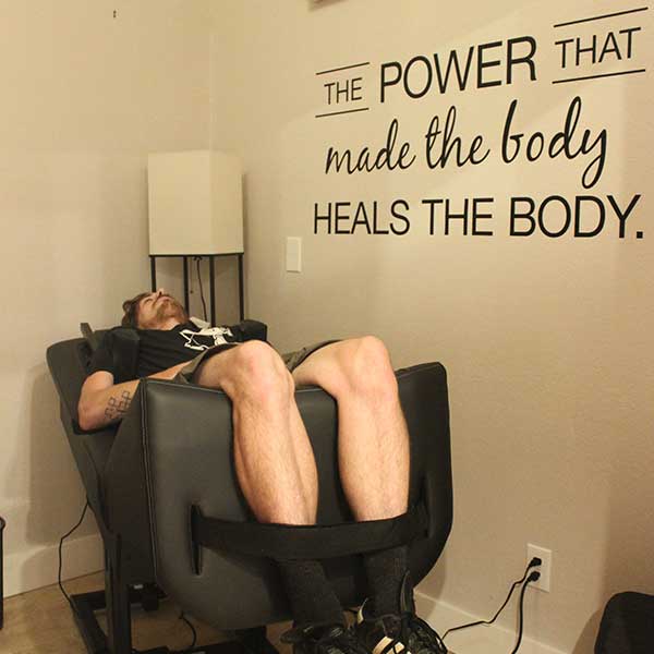A patient reclined on the Back on Trac decompression chair at Radius Chiropractic