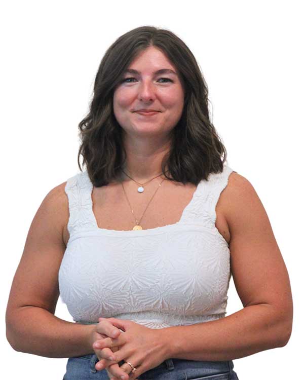 Sierra M., Chiropractic Assistant at Radius Chiropractic, smiling with hands clasped, radiating warmth and positivity.